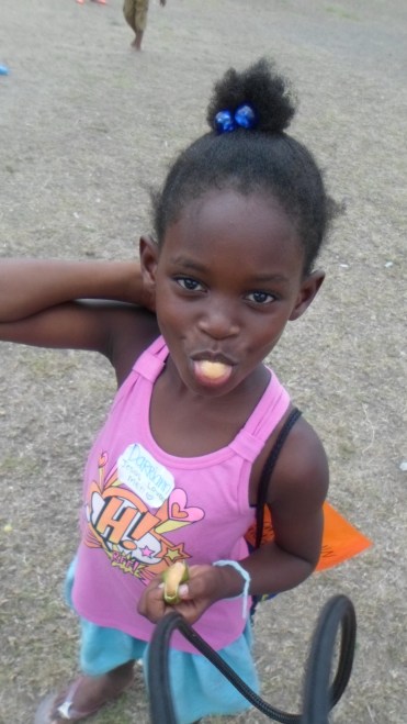 Darien eating her quenepe