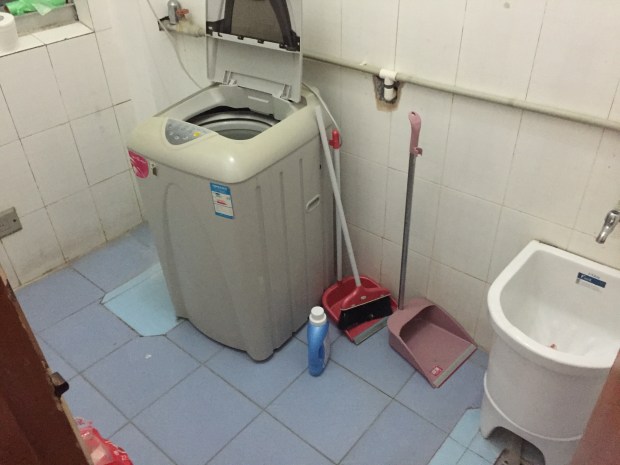 This is my laundry room. There's no need for the before picture because it looks the exact same only it didn't have my stuff in here. Thats my little washing machine. Question: does anyone know how this thing catches lint like our dryers at home?? Because it does and I just don't understand how it works... Also, the other day I almost ruined clothes because I bought bleach instead of detergent because they looked the exact same and the labels are in Chinese.