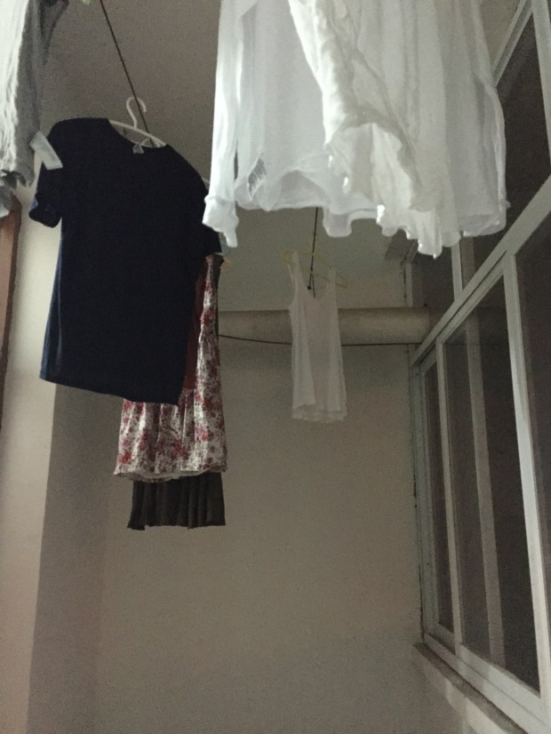 This is my second little closet. It's right off of the kitchen and it where I've been hanging my clothes to dry. I have this cool stick that I connect the hangers to so I can reach up high to hang them! It's so handy!